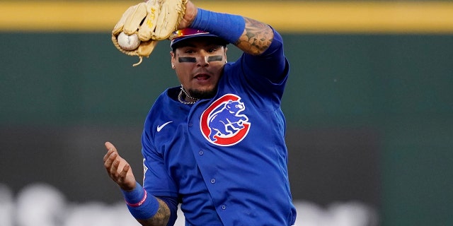 Chicago Cubs shortstop Javier Baez makes a leaping catch on a line drive hit by Cincinnati Reds' Jonathan India during the second inning of a spring training baseball game Saturday, March 27, 2021, in Goodyear, Ariz. (AP Photo/Ross D. Franklin)