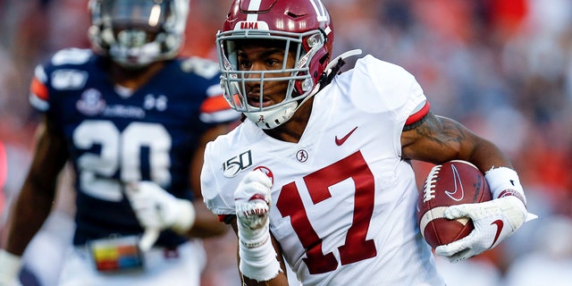 FILE - In this Saturday, Nov. 30, 2019 file photo, Alabama wide receiver Jaylen Waddle (17) carries the ball in for a touchdown after a reception in the first half of an NCAA college football game against Auburn in Auburn, Ala. (AP Photo/Butch Dill, File)