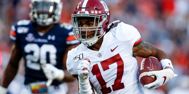 FILE - In this Saturday, Nov. 30, 2019 file photo, Alabama wide receiver Jaylen Waddle (17) carries the ball in for a touchdown after a reception in the first half of an NCAA college football game against Auburn in Auburn, Ala. (AP Photo/Butch Dill, File)