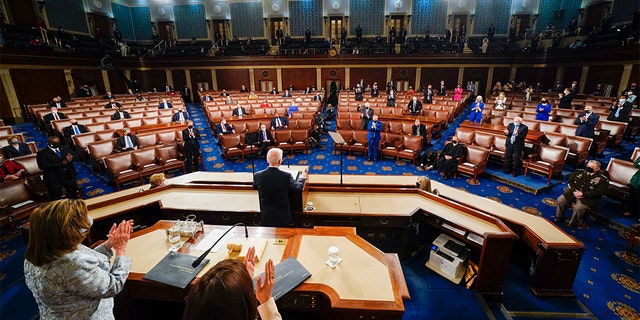 President Biden addresses a joint session of Congress, Wednesday, April 28, 2021, in the House Chamber at the U.S. Capitol in Washington, as Vice President Kamala Harris and House Speaker Nancy Pelosi of Calif., stand and applaud. (Melina Mara/The Washington Post via AP, Pool)