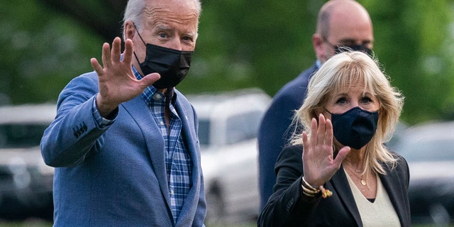 President Biden with first lady Jill Biden wave as they walk on the Ellipse near the White House after spending the weekend in Wilmington, Del., Sunday, April 25, 2021, in Washington. 