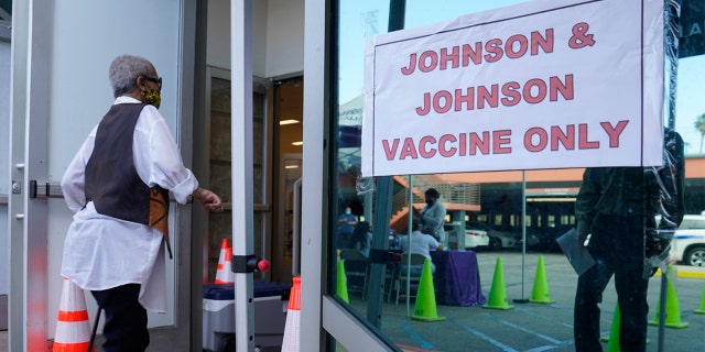 People walk in to get their COVID-19 vaccine at the Baldwin Hills Crenshaw Plaza in Los Angeles.