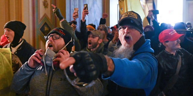 This photo shows Jon Schaffer with other demonstrators who breeched security and entered the Capitol as Congress debated the a 2020 presidential election Electoral Vote Certification. (Photo by ROBERTO SCHMIDT / AFP) (Photo by ROBERTO SCHMIDT/AFP via Getty Images)