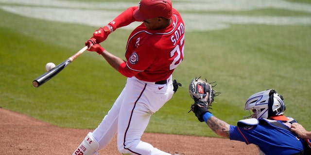 Washington Nationals' Juan Soto flies out to center field during the first inning of a spring training baseball game against the New York Mets, Sunday, March 21, 2021, in West Palm Beach, Fla. (AP Photo/Lynne Sladky)