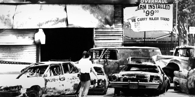 Burned-out cars at the intersection of Normandie and Florence in South Central Los Angeles after the Rodney King riots. Photographed May 1, 1992 in Los Angeles, CA. 