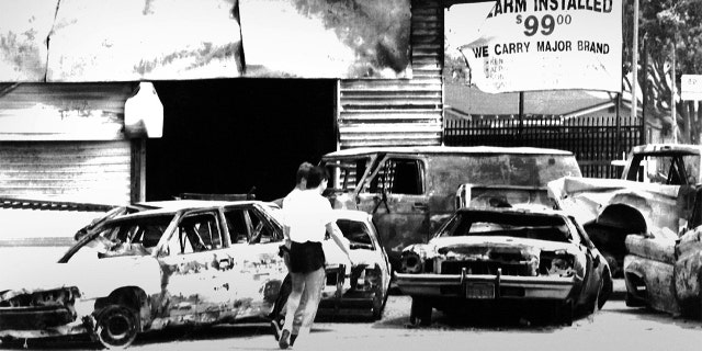 LOS ANGELES, CALIFORNIA - MAY 1: Burnt-out cars at the intersection of Normandy and Florence in south-central Los Angeles after the Rodney King riots. Photographed May 1, 1992 in Los Angeles, CA. (Photo by / The Washington Post via Getty Images)