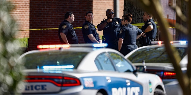 Knoxville police work the scene following a shooting at Austin-East Magnet High School in Knoxville, Tenn., Monday, April 12, 2021. 