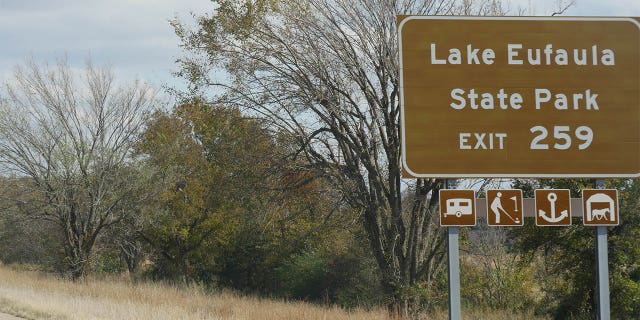 The bodies of a woman and two children were found inside a car found partially submerged in Lake Eufaula, and a possible suspect was being treated at a hospital, authorities said.