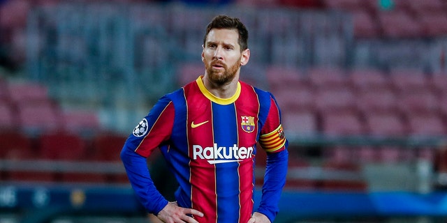 In this Tuesday, February 16, 2021 file photo, Barcelona's Lionel Messi looks on during their Champions League soccer match against Paris Saint-Germain at the Camp Nou stadium in Barcelona, ​​Spain. 
