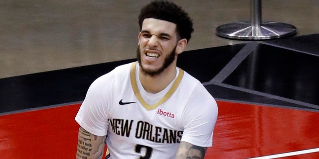 New Orleans Pelicans' Lonzo Ball sits on the court during the fourth quarter against the Houston Rockets in an NBA basketball game Sunday, April 4, 2021, in Houston. (Bob Levey/Pool Photo via AP)