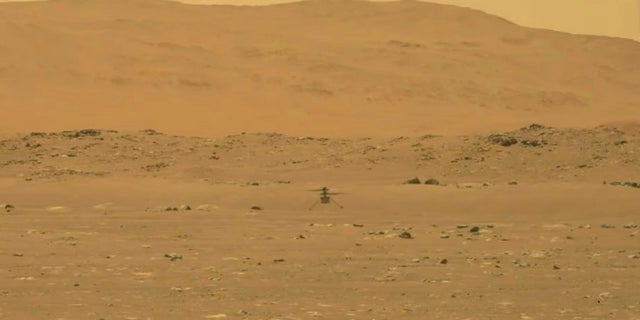 NASA's experimental Mars helicopter Ingenuity lands on the surface of Mars on Monday. (NASA/AP)