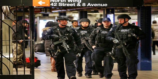 In this Dec. 12, 2017 photo, police officers patrol in the passageway connecting New York City's Port Authority bus terminal and the Times Square subway station, near the site of the explosion. (AP)