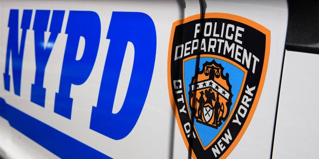 NYPD (New York Police Department) Sign with Logo on Police Patrol Car in New York City. USA