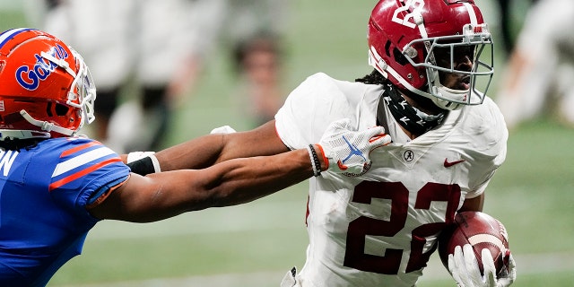 FILE - In this Saturday, Dec. 19, 2020 file photo, Alabama running back Najee Harris (22) runs into the end zone for a touchdown against Florida during the first half of the Southeastern Conference championship NCAA college football game in Atlanta. (AP Photo/John Bazemore, File)
