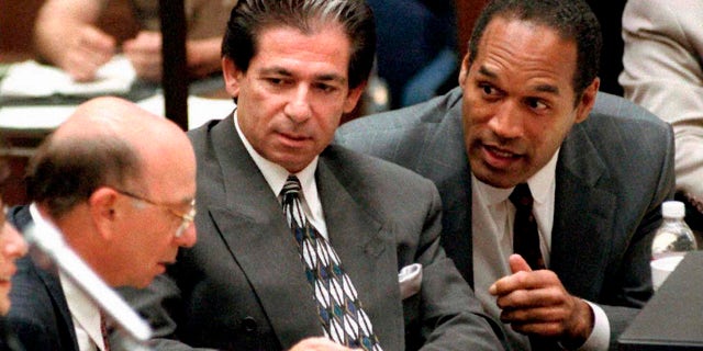 This May 3, 1995, file photo shows murder defendant O.J. Simpson, right, with friend Robert Kardashian, center, and Alvin Michelson, left, during a trial hearing in Los Angeles.