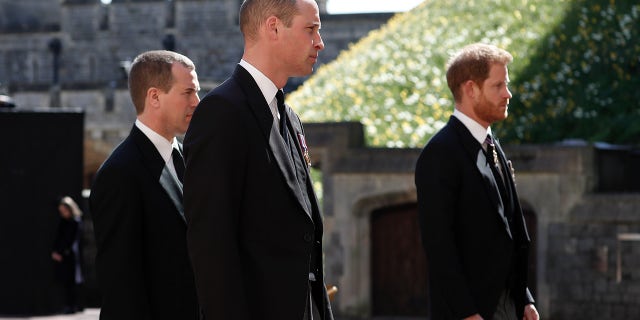 Britain's Prince Harry, right, Prince William, Peter Phillips, left, were first spotted on Saturday walking behind Philip's coffin in a ceremonial procession. 