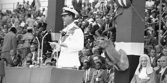 In this Dec. 12, 1963, file photo, Britain's Prince Philip delivers an address before handing over to Jomo Kenyatta, prime minister of Kenya, during the ceremony of Independence at Uhuru Stadium in Nairobi.  (AP Photo/Dennis Royle, File)