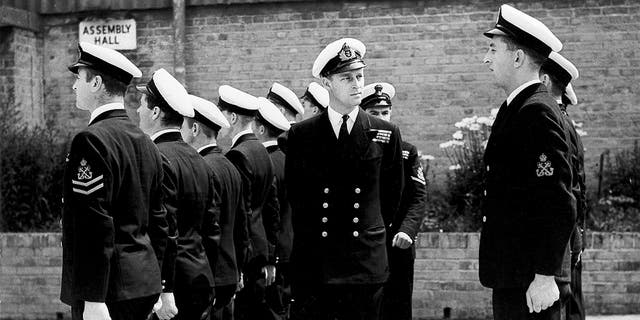 In this July 31, 1947 file photo, Lt. Philip Mountbatten, as he was then called, center, inspects his men at the Petty Officers' Training Center at Corsham, England. (AP Photo/File)