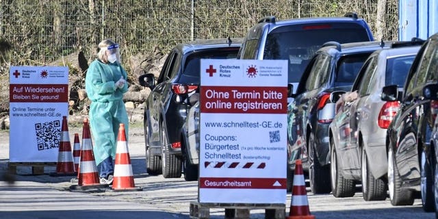 People wait in their cars for a COVID-19 rapid test at a Red Cross drive-in test center in Gelsenkirchen, Germany, Wednesday, March 31, 2021. (AP Photo/Martin Meissner)
