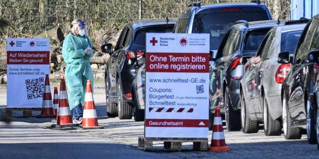People wait in their cars for a COVID-19 rapid test at a Red Cross drive-in test center in Gelsenkirchen, Germany, Wednesday, March 31, 2021. (AP Photo/Martin Meissner)