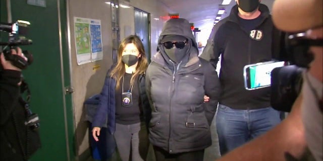 Rebecca Hillman (center), a guard at the Manhattan Detention Complex, has been charged with felony counts following the death of inmate Ryan Wilson.