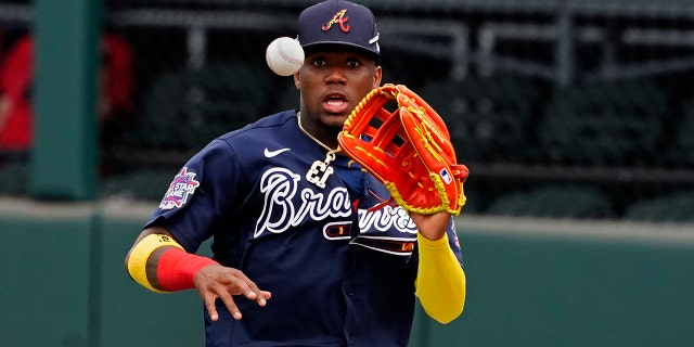 Atlanta Braves right fielder Ronald Acuna Jr. fields a ball hit for a single by Boston Red Sox' Marwin Gonzalez in the fifth inning of a spring training baseball game on Monday, March 29, 2021, in North Port, Fla. Acuna threw to third and caught J.D. Martinez trying to advance. (AP Photo/John Bazemore)