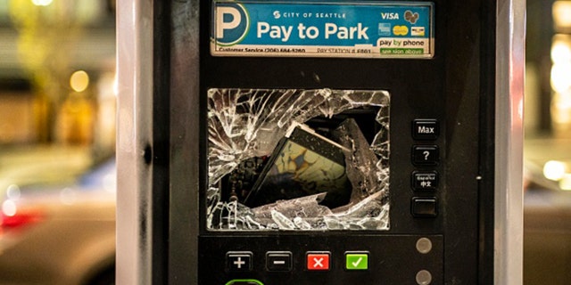 A parking pay station is damaged during a protest over the death of Daunte Wright on April 12, 2021 a Seattle, Washington. (Photo by David Ryder/Getty Images)