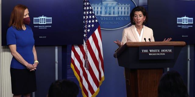 WASHINGTON, DC - APRIL 07: U.S. Secretary of Commerce Gina Raimondo speaks as White House Press Secretary Jen Psaki looks on during a daily press briefing at the James Brady Press Briefing Room of the White House April 7, 2021 in Washington, DC. Psaki held the briefing to answer questions from members of the press. (Photo by Alex Wong/Getty Images)