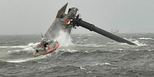 A Coast Guard Station Grand Isle 45-foot Respone Boat-Medium boatcrew heads toward a capsized 175-foot commercial lift boat Tuesday, April 13, 2021, searching for people in the water 8 miles south of Grand Isle, Louisiana. (U.S. Coast Guard Coast Guard Cutter Glenn Harris via AP)