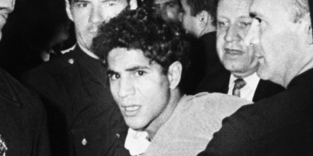 Sirhan Sirhan is led away from the Ambassador Hotel in Los Angeles after shooting Robert F. Kennedy in June 1968.