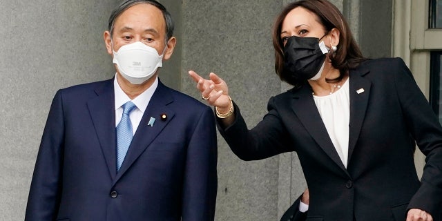 Japanese Prime Minister Yoshihide Suga meets Vice President Kamala Harris, Friday morning, April 16, 2021, on the balcony of the Eisenhower Executive Office Building on the White House campus in Washington. President Joe Biden will be welcoming Japan's prime minister to the White House on Friday in his first face-to-face meeting with a foreign leader, a choice that reflects Biden's emphasis on strengthening alliances to deal with a more assertive China and other global challenges. (AP Photo/Andrew Harnik)