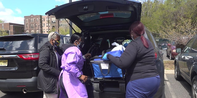 Dr. Ames-Lopez loads a vehicle up with COVID-19 vaccines for people who are homebound in Trenton, NJ. (Katie Byrne/Fox News)