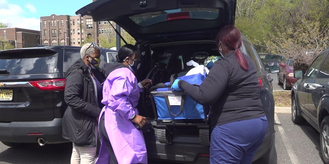Dr. Ames-Lopez loads a vehicle up with COVID-19 vaccines for people who are homebound in Trenton, NJ. (Katie Byrne/Fox News)