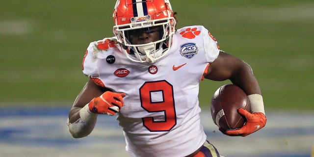 FILE - In this Saturday, Dec. 19, 2020 file photo, Clemson running back Travis Etienne (9) runs for a touchdown during the first half of the Atlantic Coast Conference championship NCAA college football game against Notre Dame in Charlotte, N.C. (AP Photo/Brian Blanco, File)