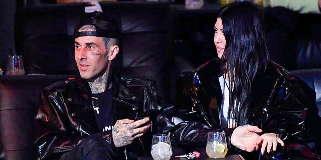 Travis Barker and Kourtney Kardashian are seen in attendance during the UFC 260 event at UFC APEX on March 27, 2021 in Las Vegas, Nevada. 