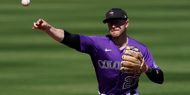 Colorado Rockies shortstop Trevor Story (27) throws to first to out Texas Rangers' Kiner-Falefa during the third inning of a spring training baseball game Monday, March 22, 2021, in Scottsdale, Ariz. (AP Photo/Ashley Landis)