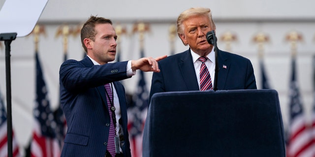 Former President Donald Trump talks with former Deputy Campaign Manager for Presidential Operations Max Miller, left before his speech to the Republican National Convention on the South Lawn of the White House, Thursday, Aug. 27, 2020, in Washington. Miller is now running for Congress against Rep. Anthony Gonzalez, R-Ohio, who voted to impeach Trump. (AP Photo/Evan Vucci)