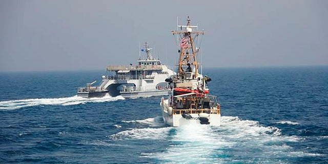 In an April 2, 2021, photo released by the U.S. Navy, an Iranian Revolutionary Guard vessels cut in front of the U.S. Coast Guard ship USCGC Monomoy in the Persian Gulf. (AP/US Navy)