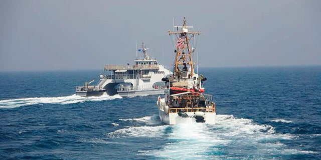 In an April 2, 2021, photo released by the U.S. Navy, an Iranian Revolutionary Guard vessels cut in front of the U.S. Coast Guard ship USCGC Monomoy in the Persian Gulf. (AP/US Navy)