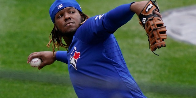 Toronto Blue Jays Vladimir Guerrero Jr. prepares to throw the ball in fielding drills during a workout, Wednesday, March 31, 2021, at Yankee Stadium in New York. The Blue Jays face the New York Yankees on opening day Thursday in New York. (AP Photo/Kathy Willens)