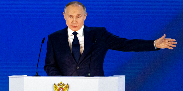 Russian President Vladimir Putin gestures as he gives his annual state of the nation address in Manezh, Moscow, Russia.