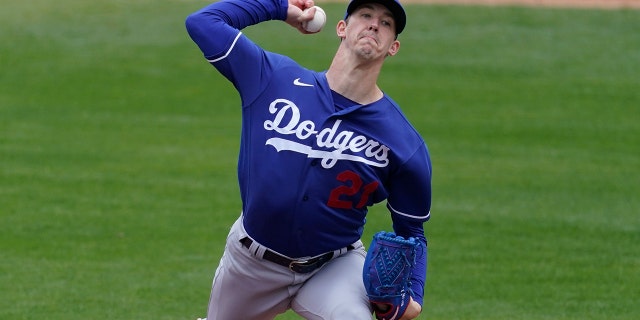 Los Angeles Dodgers starting pitcher Walker Buehler (21) throws during the first inning of a spring training baseball game against the Milwaukee Brewers Tuesday, March 23, 2021, in Phoenix, Ariz. (AP Photo/Ashley Landis)