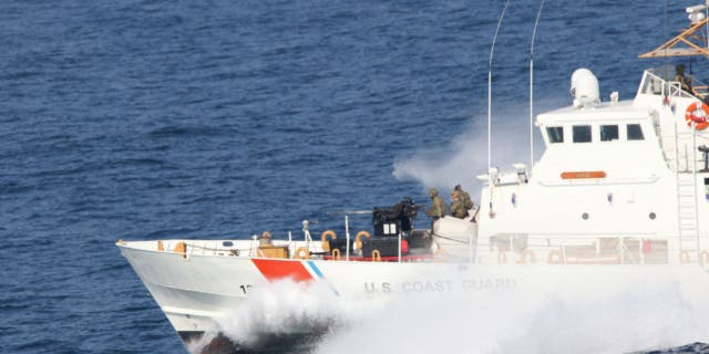 U.S. Coast Guardsmen aboard the Coast Guard patrol boat USCGC Adak stand security watch during a Strait of Hormuz transit, Dec. 8, 2020. (U.S. Navy photo by Mass Communication Specialist 2nd Class Indra Beaufort)