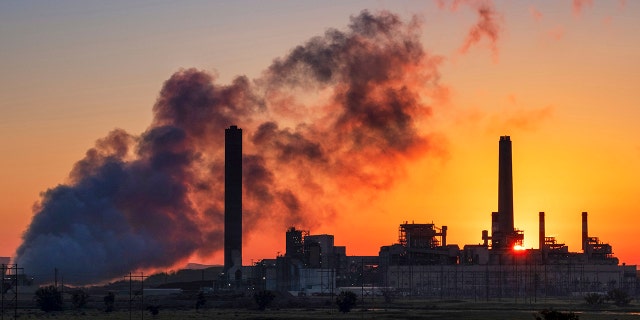 FILE - In this July 27, 2018, file photo, the Dave Johnson coal-fired power plant is silhouetted against the morning sun in Glenrock, Wyo. (AP Photo/J. David Ake, File)