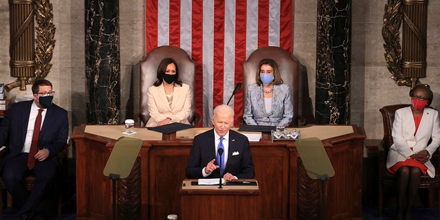 President Joe Biden addresses a joint session of Congress, Wednesday, April 28, 2021, in the House Chamber at the U.S. Capitol in Washington, as Vice President Kamala Harris, left, and House Speaker Nancy Pelosi of Calif., look on. (Chip Somodevilla/Pool via AP)