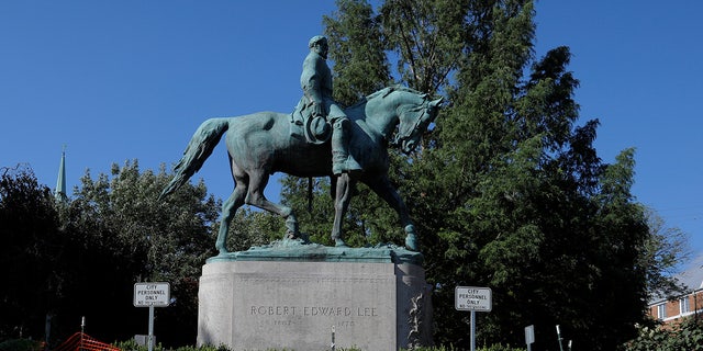 A pedestrian walks past a statue of Civil War Confederate General Robert E. Lee, ahead the one-year anniversary of the fatal white-nationalist rally, in Charlottesville, Virginia, U.S., August 1, 2018.  