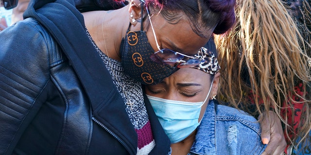 DMX's ex-wife, Tashera Simmons, left, and his fiancée Desiree Lindstrom embrace them during a prayer vigil outside White Plains Hospital on Monday, April 5th.