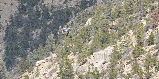 A helicopter crew spotted Schnitzer's body at the bottom of an 80-foot cliff, the sheriff's office said.