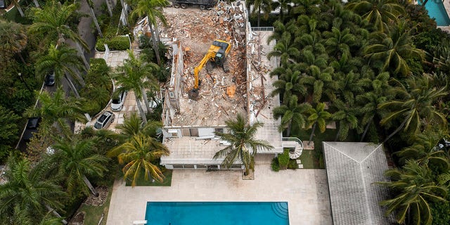 April 20, 2021; Palm Beach, FL, USA; BG Group Demolition crews tear down the Palm Beach home of late financier and sex offender Jeffrey Epstein in Palm Beach, Florida on April 20, 2021. Mandatory Credit: Greg Lovett-USA TODAY NETWORK