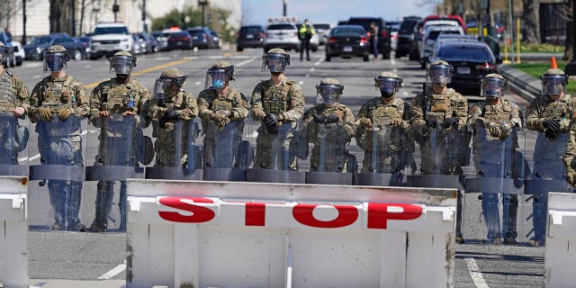 Troops stand guard near the scene of a car that crashed into a barrier on Capitol Hill in Washington, Friday, April 2, 2021. (AP Photo/Patrick Semansky)